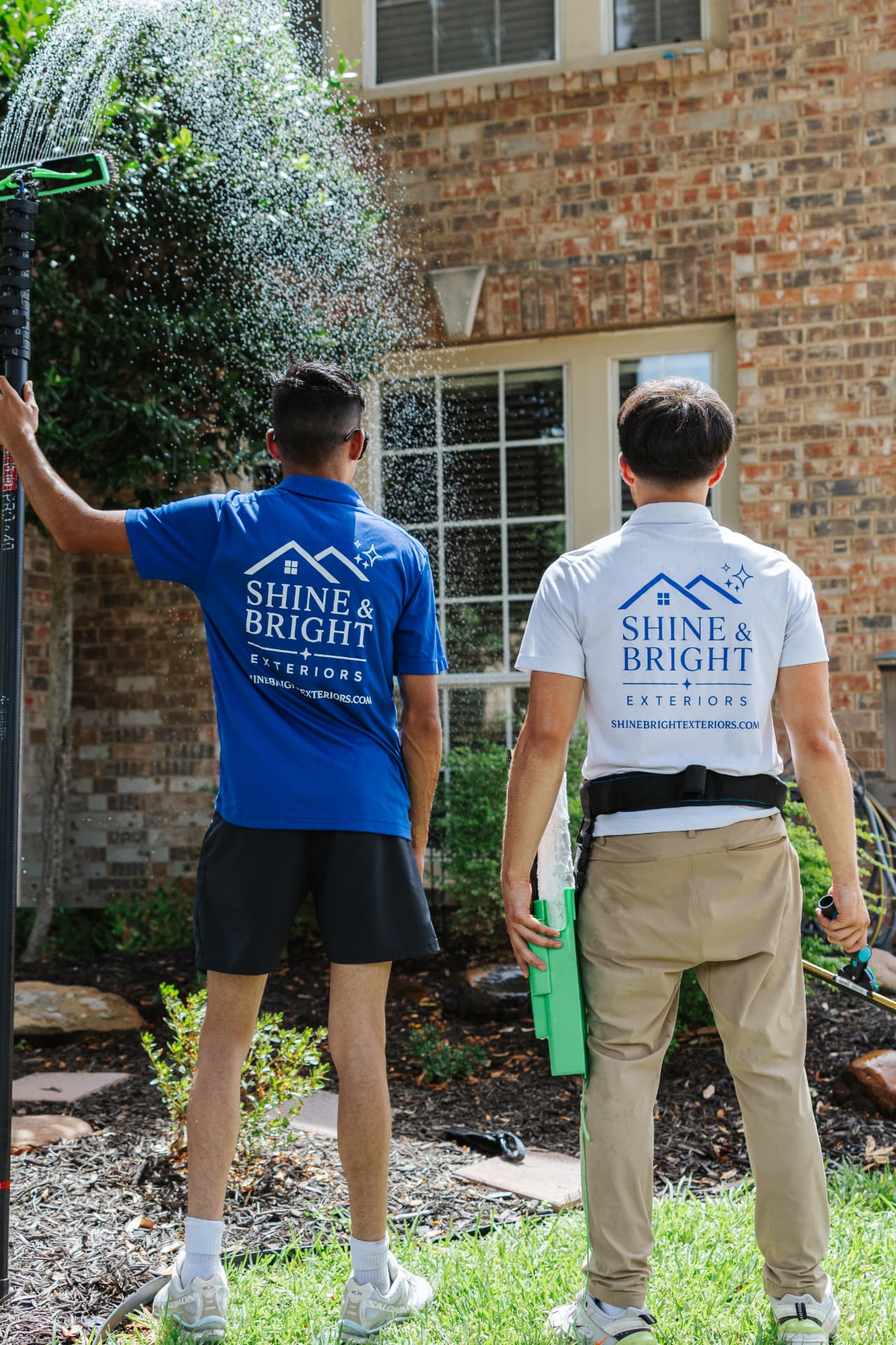 Shine & Bright team detailing a large residential window